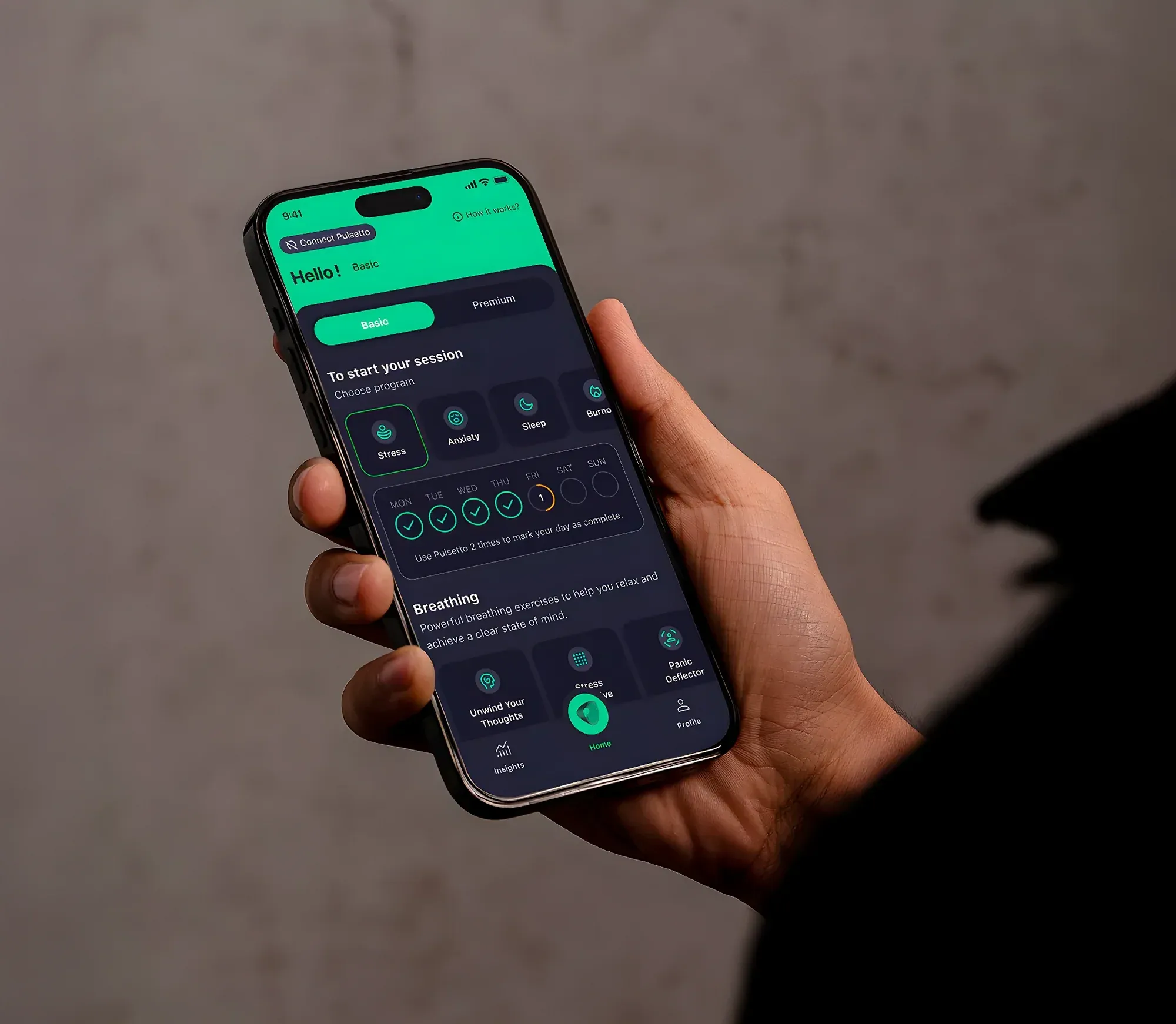Hands holding the Pulsetto FIT device